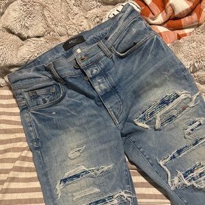 AMIRI Light Blue Denim Jeans with Black Leather Label